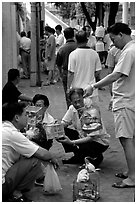 Peddling birds on the street. Guangzhou, Guangdong, China ( black and white)