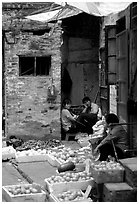 Fruit vendors in a narrow alley. Guangzhou, Guangdong, China ( black and white)