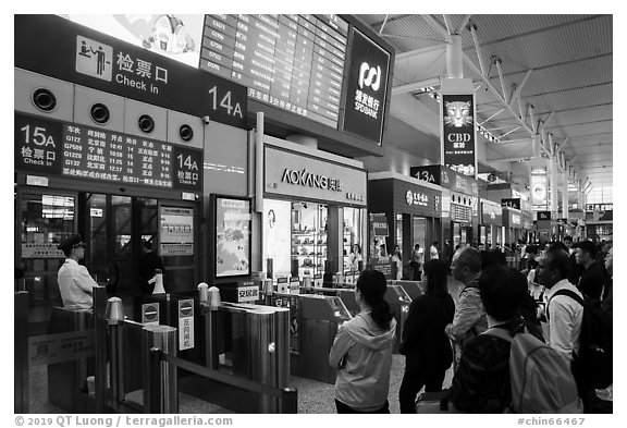 Hongqiao Railway Station platform gate. Shanghai, China (black and white)