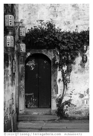 Wooden door with lanterns and flowers. Hongcun Village, Anhui, China (black and white)