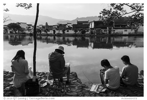 Art students painting along South Lake. Hongcun Village, Anhui, China (black and white)