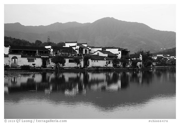 Hongcun village and mountains reflected in South Lake. Hongcun Village, Anhui, China (black and white)
