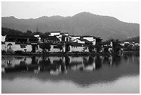 Hongcun village and mountains reflected in South Lake. Hongcun Village, Anhui, China ( black and white)