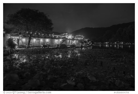 Houses reflected in South Lake at night. Hongcun Village, Anhui, China (black and white)
