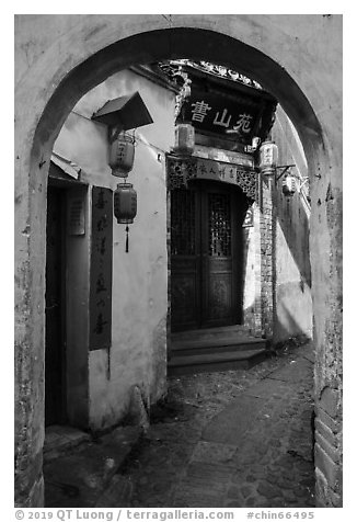 Alley framed by archway. Hongcun Village, Anhui, China (black and white)