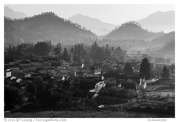 Village and hills in morning fog. Xidi Village, Anhui, China (black and white)