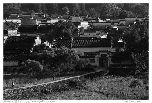 Man on path to village. Xidi Village, Anhui, China (black and white)