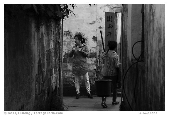 Two women in alley. Xidi Village, Anhui, China (black and white)