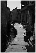 Woman carrying buckets. Xidi Village, Anhui, China ( black and white)