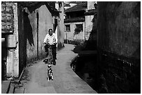 Dog and man on bike. Xidi Village, Anhui, China ( black and white)