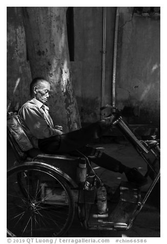 Man sleeping on cyclo. Xidi Village, Anhui, China (black and white)