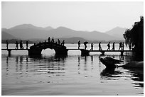 People walking on Yongjin Bridge, West Lake. Hangzhou, China ( black and white)