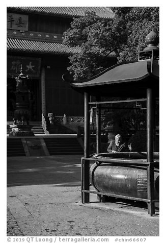 Woman at incense urn, Jingci Temple. Hangzhou, China (black and white)