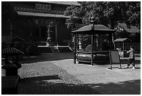 Woman offering incense, Jingci Temple. Hangzhou, China ( black and white)