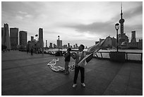 Men preparing to fly kites. Shanghai, China ( black and white)