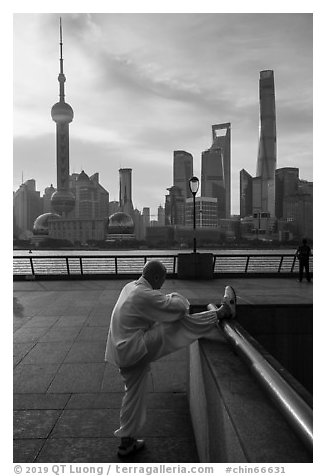 Man stretching and Oriental Pearl Tower, the Bund. Shanghai, China (black and white)