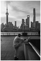 Man stretching and Oriental Pearl Tower, the Bund. Shanghai, China ( black and white)