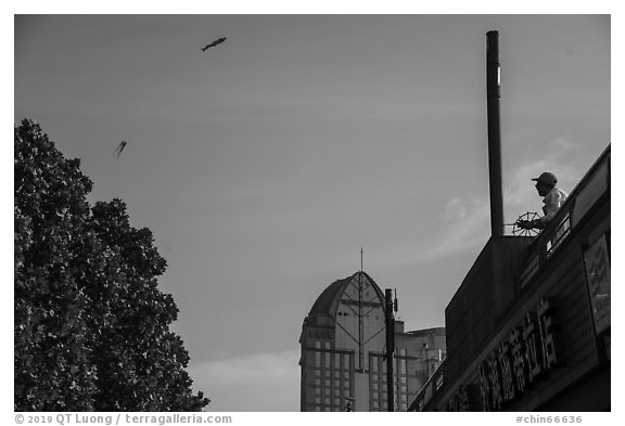 Man flying kite, the Bund. Shanghai, China (black and white)