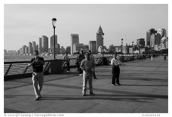 Men flying kites, the Bund. Shanghai, China (black and white)