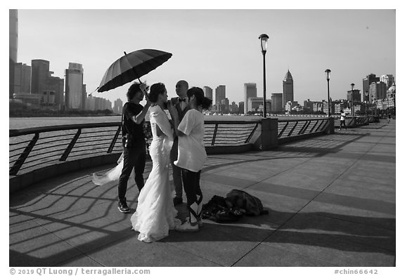 Bride and groom setting up for photos, the Bund. Shanghai, China (black and white)