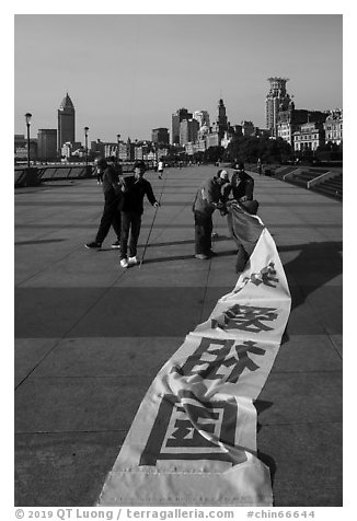 Men folding kite, the Bund. Shanghai, China (black and white)