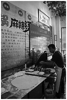Man preparing breakfast pancakes. Shanghai, China ( black and white)