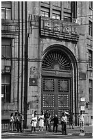 People standing in front of historic bank gate. Shanghai, China ( black and white)