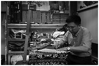 Man working on fan. Shanghai, China ( black and white)