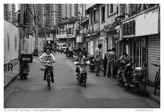 Old Street lined with old buidings and modern towers. Shanghai, China (black and white)