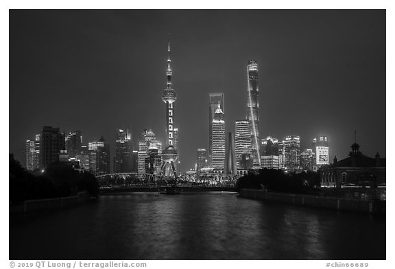 Garden Bridge, Peoples Memorial and city skyline at night. Shanghai, China (black and white)