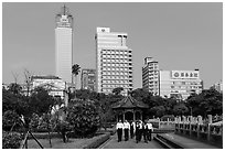 Office workers, 2-28 Peace Park, and high rises. Taipei, Taiwan (black and white)