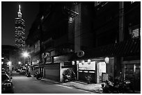 Dark street, store with lanters, and Taipei 101. Taipei, Taiwan ( black and white)