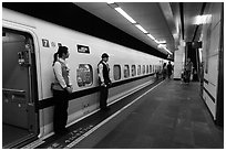 Hostess in front of High Speed Rail (HSR) car. Taipei, Taiwan ( black and white)