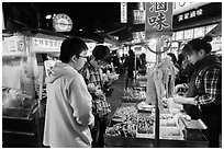 Customer buying foods at Shilin Night Market. Taipei, Taiwan (black and white)