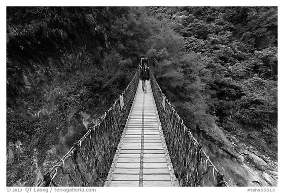 Hiker on suspension footbridge, Taroko Gorge. Taroko National Park, Taiwan (black and white)