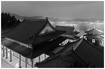 Wen Wu temple at night with light trails from boats. Sun Moon Lake, Taiwan (black and white)