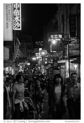 People on main street at night, Shueishe Village. Sun Moon Lake, Taiwan (black and white)
