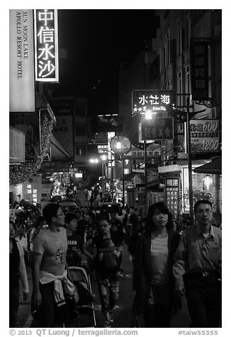 People on main street at night, Shueishe Village. Sun Moon Lake, Taiwan (black and white)