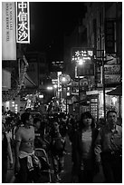 People on main street at night, Shueishe Village. Sun Moon Lake, Taiwan (black and white)