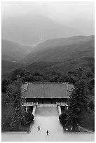 Two people, temple, and misty mountains, Tsen Pagoda. Sun Moon Lake, Taiwan (black and white)