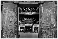 Painted doors, looking towards gate at night, Tienhou Temple. Lukang, Taiwan (black and white)