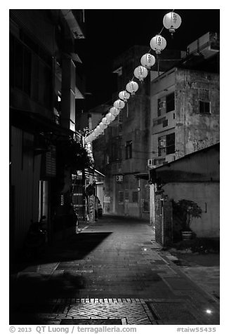 Red paper lanterns glowing in  Nine-turns lane at night. Lukang, Taiwan (black and white)