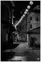 Red paper lanterns glowing in  Nine-turns lane at night. Lukang, Taiwan (black and white)