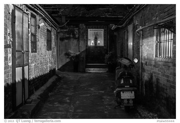 Alley at night with temple altar glowing red. Lukang, Taiwan (black and white)