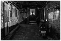 Alley at night with temple altar glowing red. Lukang, Taiwan ( black and white)