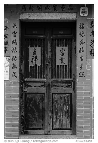 Wooden door with chinese writing on red paper. Lukang, Taiwan (black and white)