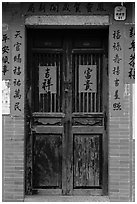 Wooden door with chinese writing on red paper. Lukang, Taiwan (black and white)