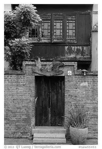 Brick wall and historic wooden house. Lukang, Taiwan (black and white)