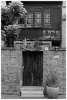 Brick wall and historic wooden house. Lukang, Taiwan (black and white)