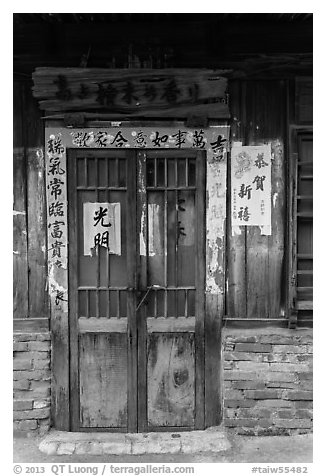 Door with weathered wood and inscriptions. Lukang, Taiwan (black and white)